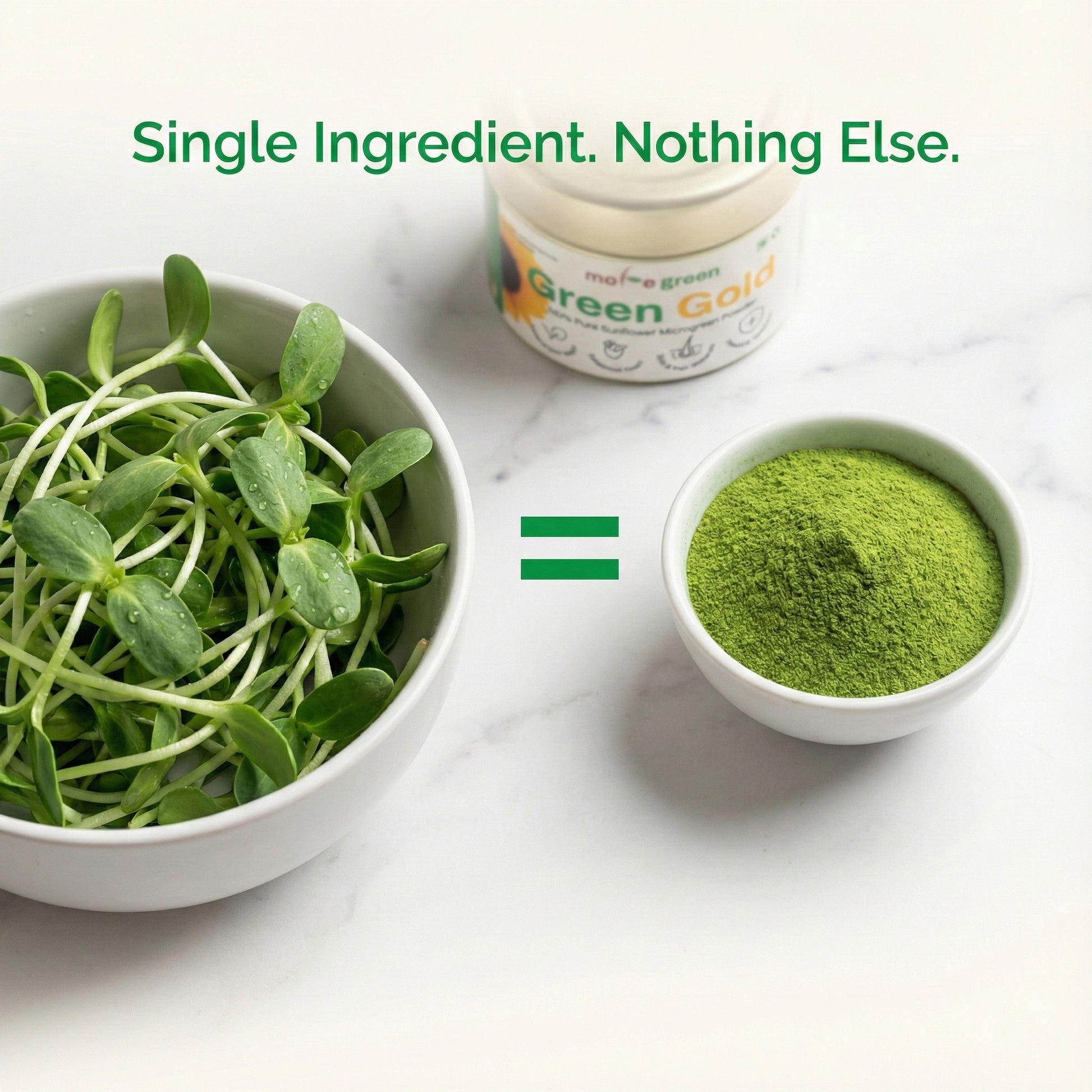 Bowl of green leafy vegetables and a container labeled 'Green Gold' on a white surface.